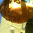 A pixelated close-up of a figure with brown hair and a light-colored top against a blue background.