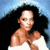 Pixelated image of a person with dark hair and light skin, wearing a white garment, against a blue background.