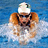 Pixelated image of a swimmer in motion wearing white cap, dark goggles, and orange swimsuit with water splashing around.