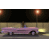 Animated sequence of a pink convertible car driving left to right under streetlights at night with visible wheel rotation.