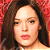 Static pixelated image of a person with long dark hair against a red background, rendered in low-resolution 256x256 pixels.