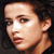 Static pixelated image of a person's face with dark hair and light skin tone against a black background.