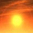 A static pixelated image of a bright yellow-orange sun centered against a gradient sky transitioning from deep orange to brown at the top.