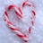 A heart-shaped candy cane on a light blue background with red text reading 'Believe In What Your <3 Is Saying' and 'Hear The Melody Thats Playing' in pixelated font.