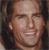 Pixelated close-up of a person's face with light skin tone, dark hair, and a wide open mouth showing teeth, set against a dark background.