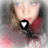 six pixelated showing a person with light brown hair and blue eyes, wearing a red top against a blurred background