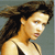 Pixelated static image of a woman with long dark hair wearing a black strap top against a gray background.