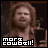 A 4-frame animated contact sheet showing a person with long hair in various poses holding drumsticks, each frame featuring the text "more cowbell!" at the bottom.