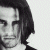 Black-and-white pixelated portrait of a person with shoulder-length dark hair on left, green background with bright green text "Original Icons .com" on right.