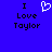 Blue background with black text 'I Love Taylor' on left and right, white pixelated heart symbol between them.