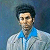 Static pixelated image of a person in a light jacket with blue collar against dark background, rendered at low resolution.