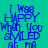Blue text on a teal background reads "I Was Happy When You Smiled at Me" in six repeated with alternating light blue and teal backgrounds