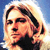 Pixelated static image of a person's face with light brown hair against a blue sky background, rendered in low-resolution 256x256 pixels.