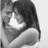 Black-and-white pixelated image of a person with dark hair holding an object near their face against a light background.