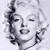 Pixelated grayscale portrait of a woman with closed eyes, styled hair, and a subtle smile, cropped to show head and shoulders against a light background.