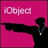 Pixelated pink background with a black silhouette pointing left, overlaid text in white pixel font reading "iObject" and "OMG THE WORLD IS GOING NUTS Oh well. Who cares. I mean REALLY.".