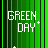 Green vertical stripes background with white text 'GREEN DAY' and a plus sign, scattered white crosses, orange pixel clusters on right side.