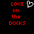 Red pixelated text 'LOVE on the DOCKS' with a white heart symbol above 'LOVE', displayed against black background.