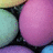 Pixelated static image showing a large pink sphere with gradient shading, partially obscured by dark angular shapes against a teal background.