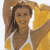 Pixelated static image of a person in yellow athletic wear with white straps, arms raised, against a light background.