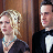 Static 48x48 pixel icon showing two people in formal attire against a brown background, with visible dithering and low-resolution rendering artifacts.