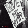 Black-and-white image of a person holding a sign reading "LOVE NOT WAR" with a peace symbol above "LOVE", displayed in a of six with red and white progress indicators