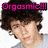 A pixelated image of a person with dark curly hair wearing a light gray shirt, featuring pink text reading "Orgasmic!!!" above the head on one side.