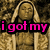 Pixelated image of a Buddha statue with text overlays in pink, green, and blue.