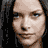 Pixelated portrait of a woman with long dark hair and blue eyes, displayed across multiple showing varying brightness levels