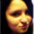 Pixelated close-up of a smiling face with warm yellow and orange tones against dark background.