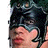 Pixelated static image of a person's face with dark hair and closed eyes, partially obscured by pixelation artifacts.