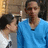 Three people in a group pose with one person in a blue shirt turning their head slightly left to right across frames.
