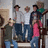 Group of five people standing together in a pixelated image with varied clothing colors and poses.