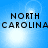 Blue background with four identical displaying 'NORTH CAROLINA' text and bright light effects