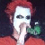 Two side-by-side pixelated figures with white faces, one in red hair and orange clothing, the other in blue hair and light clothing, both holding hands near their mouths.