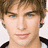 A pixelated portrait of a person with light brown hair and blue eyes appears on the left, while three large black letters O, M, G are displayed in white outlines against bright pink backgrounds.