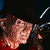 A pixelated character with brown hair and a black hat wears a red shirt, shown in four where the head turns slightly left to right