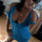 Pixelated static image of a figure in blue attire with brown hair against a blurred background.