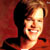 Pixelated static image of a person with light brown hair and fair skin against a red background, featuring visible dithering and color blending artifacts.