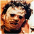 Pixelated static image of a person with dark hair and light skin, wearing a dark shirt against an orange-brown background.