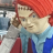 Pixelated image of a character with red hair, light skin, and a blue and red outfit against a blurred background.