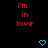 Red pixelated text 'i'm in love' on black background with two blue heart icons below, one static and one animated.