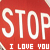 Red background with large white text reading STOP above smaller I LOVE YOU text, pixelated rendering.
