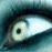 A pixelated close-up of a human eye with blue-toned skin and eyelashes, next to green text reading 'Original Icons .com' on a dark background.