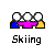 Three pixelated figures with white circular heads stand side-by-side, wearing blue, pink, and yellow clothing against a gray background.