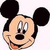 Pixelated cartoon head of a mouse character with large black ears, beige face, and smiling expression on white background.