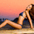 A pixelated image of a woman lying on her side with one arm raised, set against a gradient sky background.
