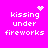 Pixelated text 'kissing under fireworks' on bright pink background with animated heart and starburst symbols above and to the right.