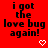 Red background with black pixelated text reading 'i got the love bug again!' and two white heart symbols at bottom right.