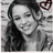 Black-and-white photo of a smiling person with long dark hair, overlaid with pink text and a red heart symbol.